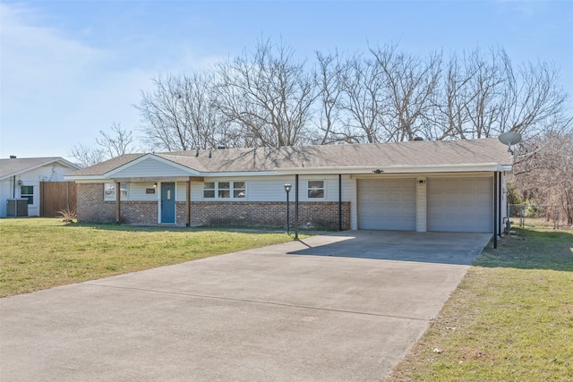 ranch-style house with a garage, a front lawn, and central air condition unit