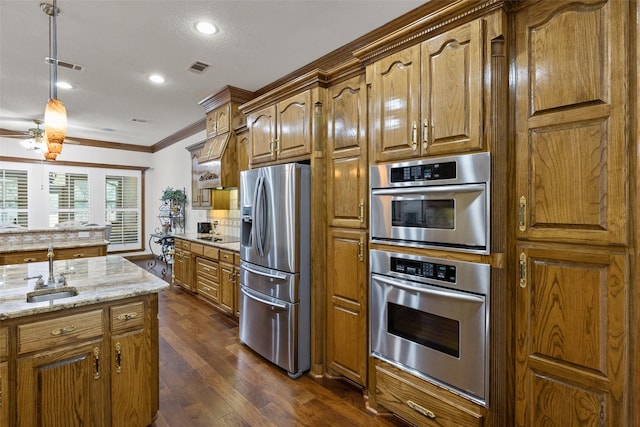 kitchen featuring sink, stainless steel appliances, crown molding, light stone countertops, and dark wood-type flooring