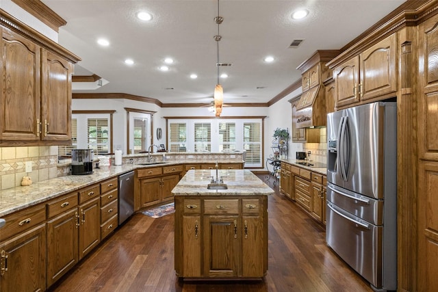 kitchen featuring pendant lighting, sink, a center island, kitchen peninsula, and stainless steel appliances