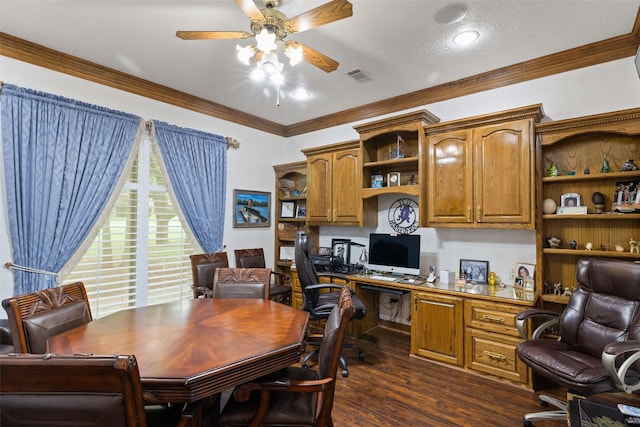 home office with dark hardwood / wood-style floors, built in desk, ceiling fan, crown molding, and a textured ceiling