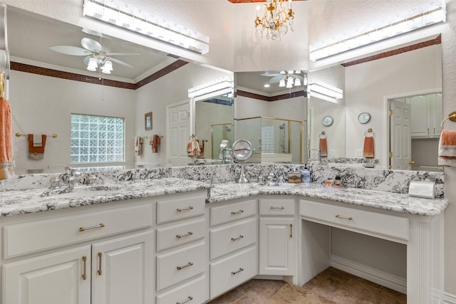 bathroom with tile patterned floors, a shower with shower door, crown molding, vanity, and ceiling fan