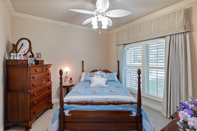 bedroom featuring crown molding, light colored carpet, and ceiling fan