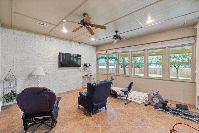 workout area with brick wall and light tile patterned floors