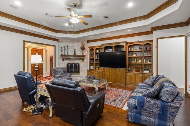 living room with dark hardwood / wood-style flooring and a raised ceiling