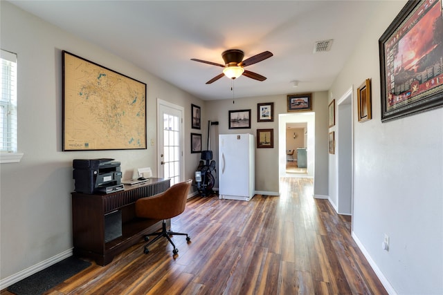 home office featuring dark wood-type flooring and ceiling fan