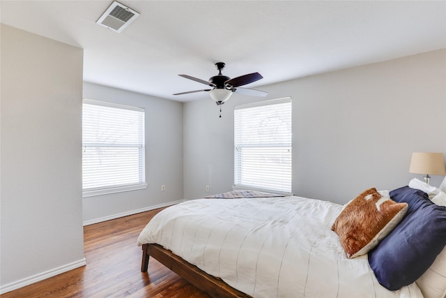 bedroom with hardwood / wood-style floors and ceiling fan