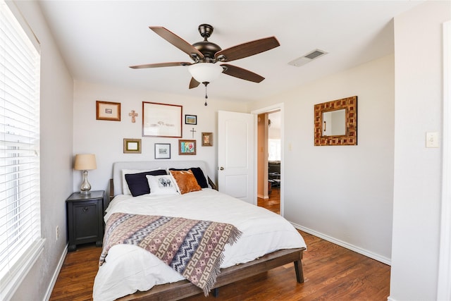 bedroom with ceiling fan and dark hardwood / wood-style floors