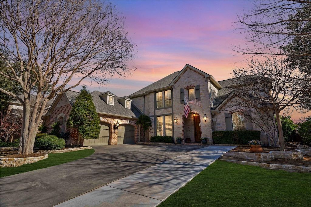 french provincial home with a garage