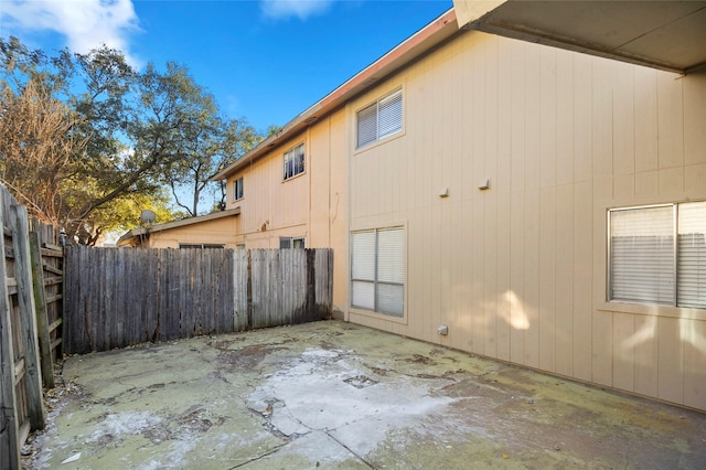 view of side of property with a patio and a fenced backyard