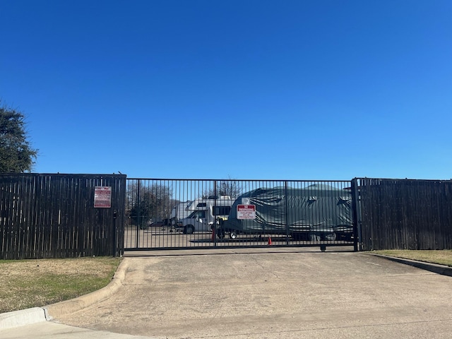 view of gate featuring fence