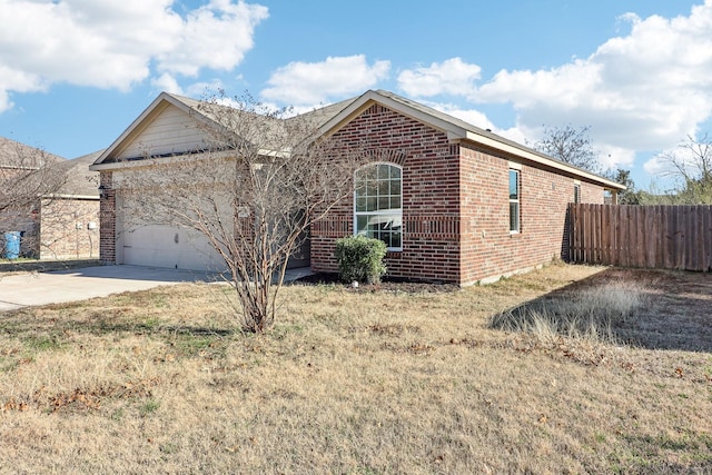 ranch-style house with a garage, fence, brick siding, and concrete driveway