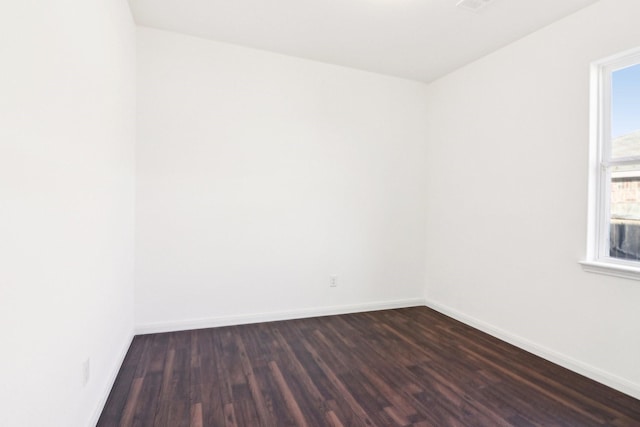 unfurnished room with dark hardwood / wood-style flooring