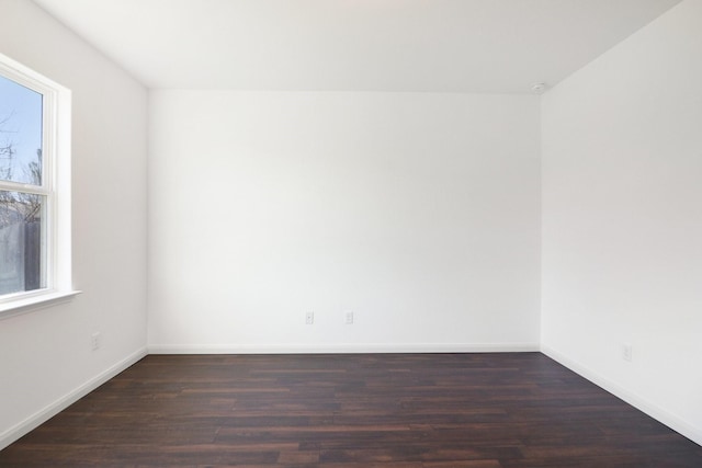 unfurnished room with dark hardwood / wood-style floors