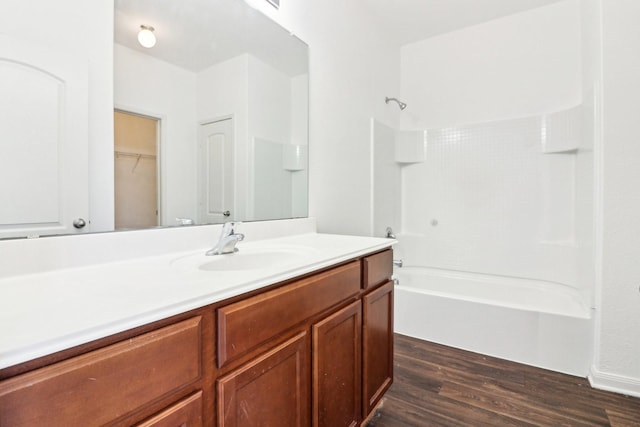 bathroom featuring vanity, wood-type flooring, and shower / bath combination