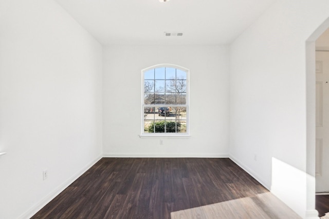 spare room featuring dark hardwood / wood-style floors