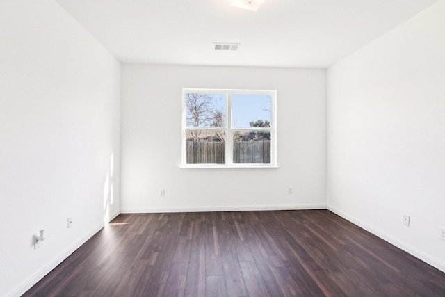 empty room with dark hardwood / wood-style floors