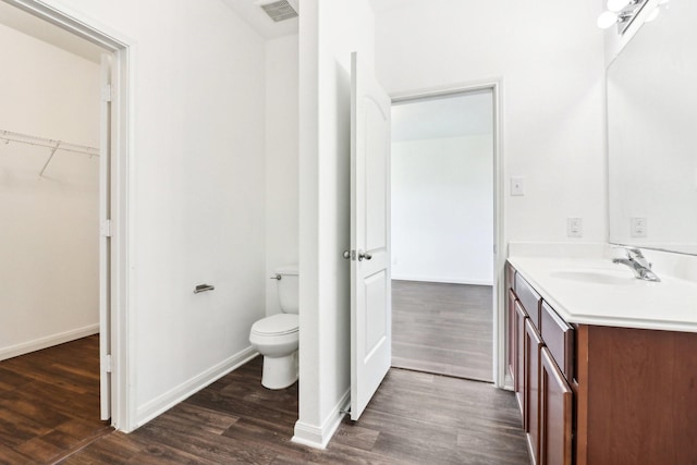 bathroom featuring hardwood / wood-style flooring, vanity, and toilet