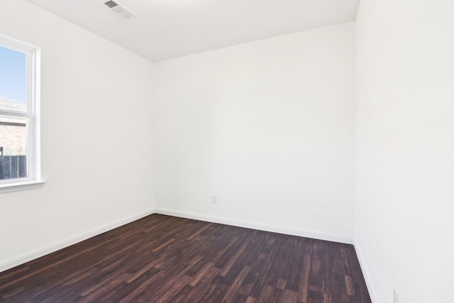 unfurnished room with dark hardwood / wood-style floors