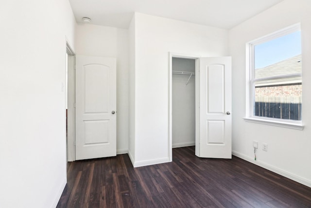 unfurnished bedroom featuring dark hardwood / wood-style floors and a closet