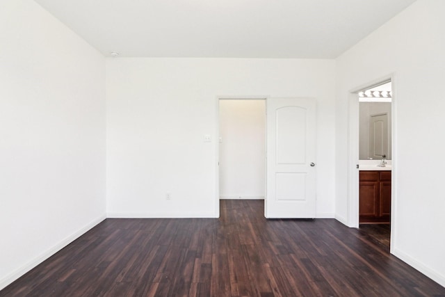 empty room featuring dark hardwood / wood-style floors and sink