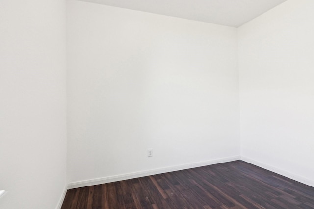 spare room with dark hardwood / wood-style flooring