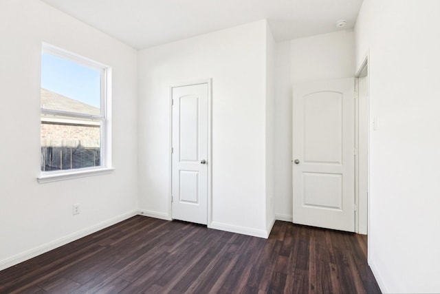 unfurnished bedroom with dark hardwood / wood-style floors