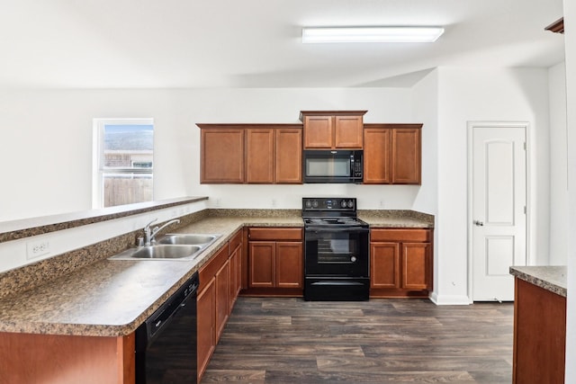 kitchen with sink, dark hardwood / wood-style floors, black appliances, and kitchen peninsula