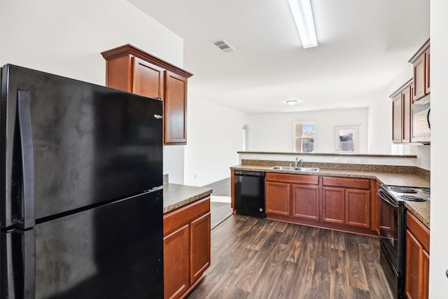 kitchen featuring dark wood-type flooring, sink, kitchen peninsula, and black appliances