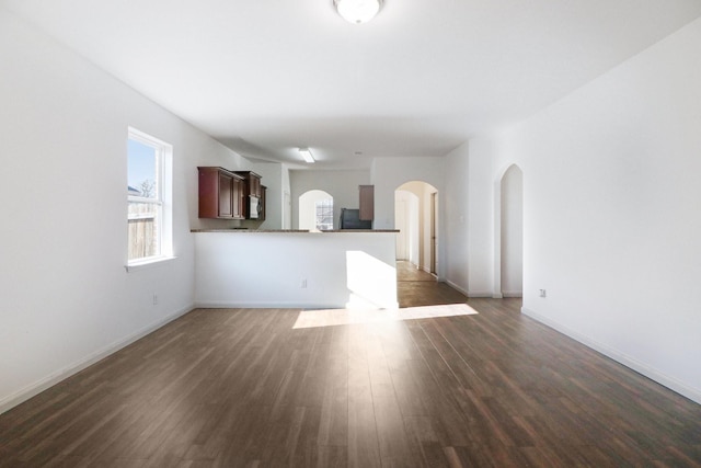 unfurnished living room featuring dark wood-type flooring