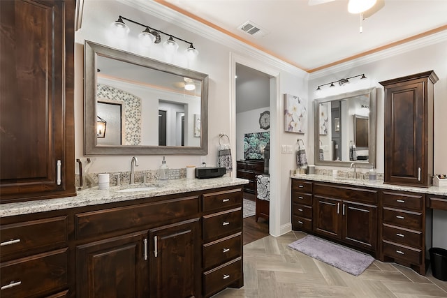 bathroom featuring crown molding, parquet flooring, vanity, and ceiling fan