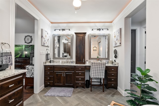 bathroom with parquet floors, vanity, and crown molding