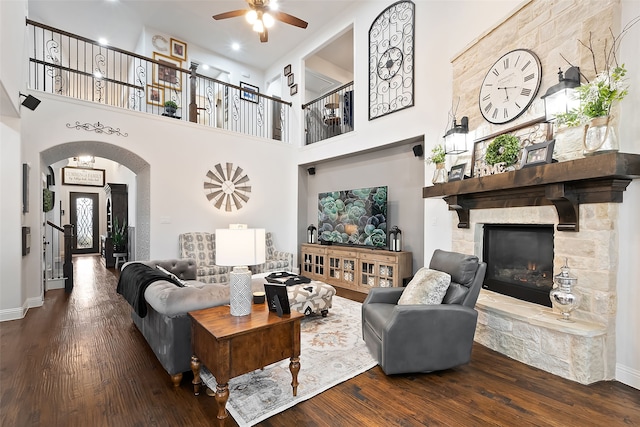 living room with ceiling fan, a fireplace, and hardwood / wood-style floors