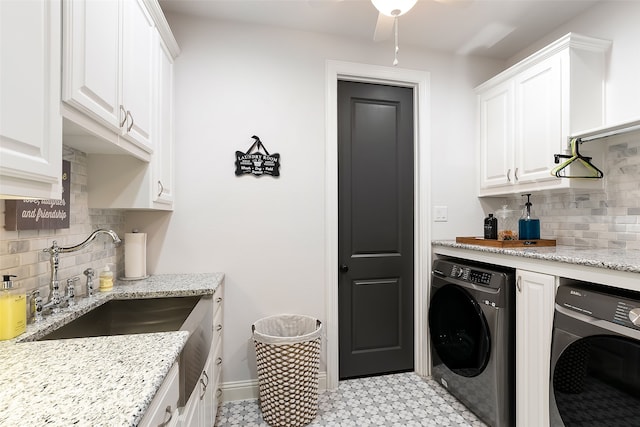 washroom featuring cabinets, separate washer and dryer, and sink