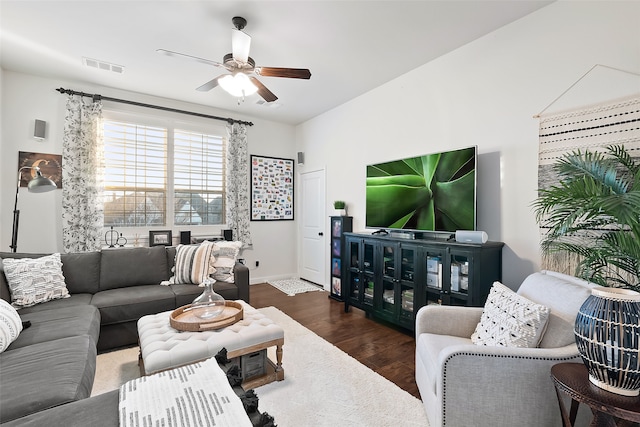 living room featuring dark hardwood / wood-style floors and ceiling fan