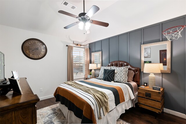 bedroom with dark hardwood / wood-style flooring and ceiling fan