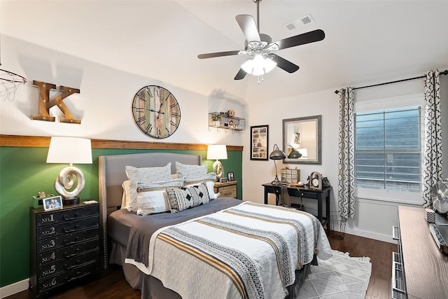 bedroom with dark hardwood / wood-style flooring and ceiling fan