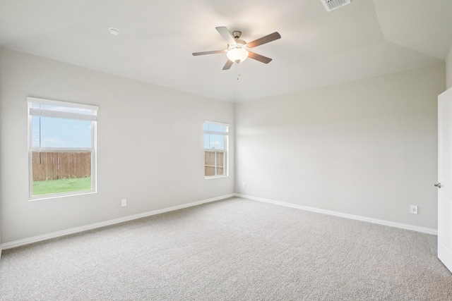 spare room featuring ceiling fan, plenty of natural light, and carpet floors