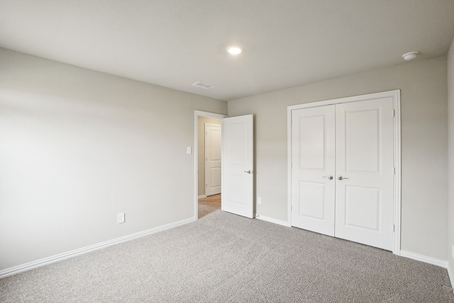 unfurnished bedroom with carpet floors and a closet