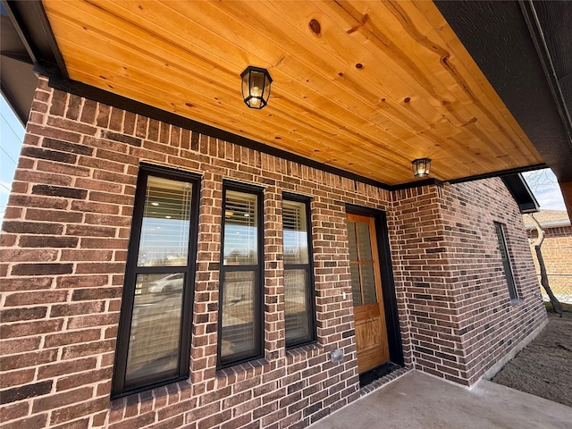 doorway to property with brick siding