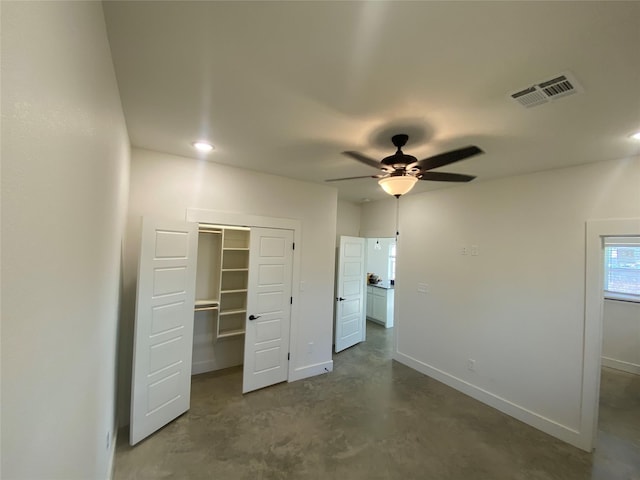 unfurnished bedroom featuring a walk in closet, ceiling fan, and a closet