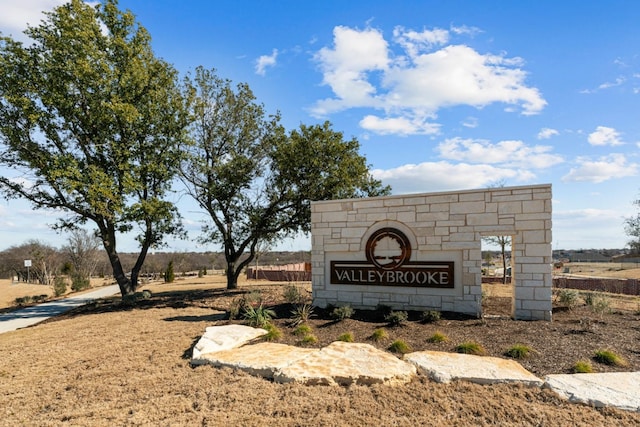 community / neighborhood sign featuring a rural view