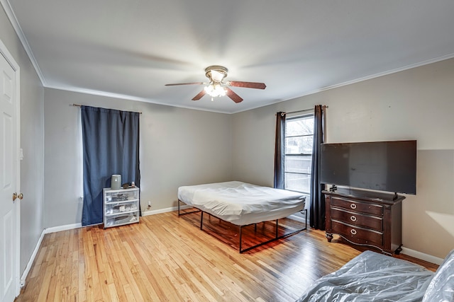 bedroom featuring ornamental molding, ceiling fan, and light hardwood / wood-style floors