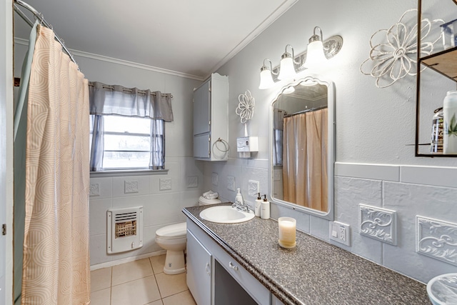 bathroom featuring heating unit, tile walls, tile patterned flooring, vanity, and ornamental molding