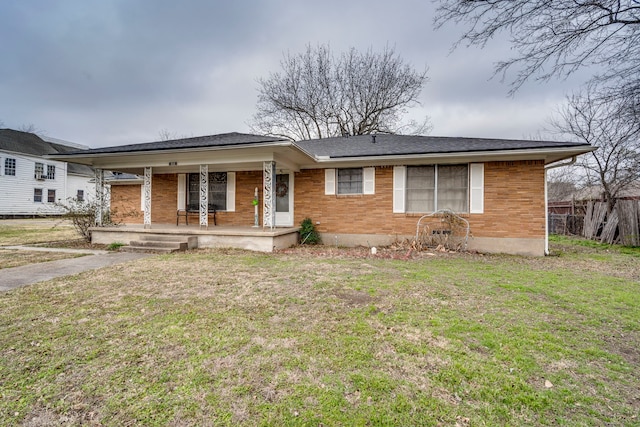 ranch-style home with a front yard and covered porch