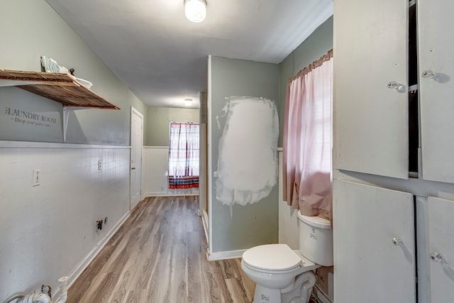 bathroom featuring hardwood / wood-style floors and toilet