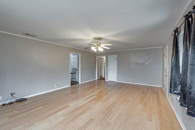 spare room featuring ceiling fan, ornamental molding, and light hardwood / wood-style floors