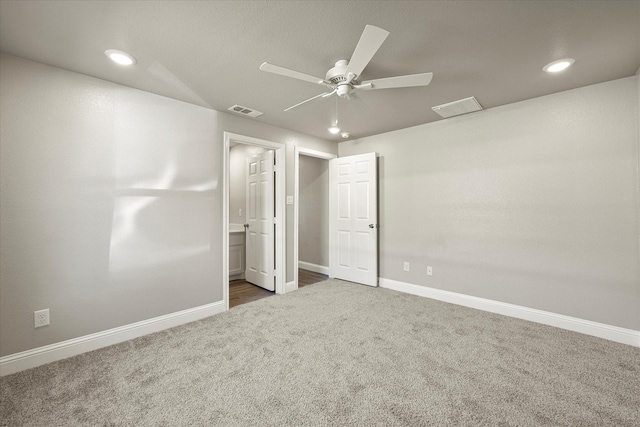 unfurnished bedroom featuring ensuite bath, ceiling fan, and carpet flooring