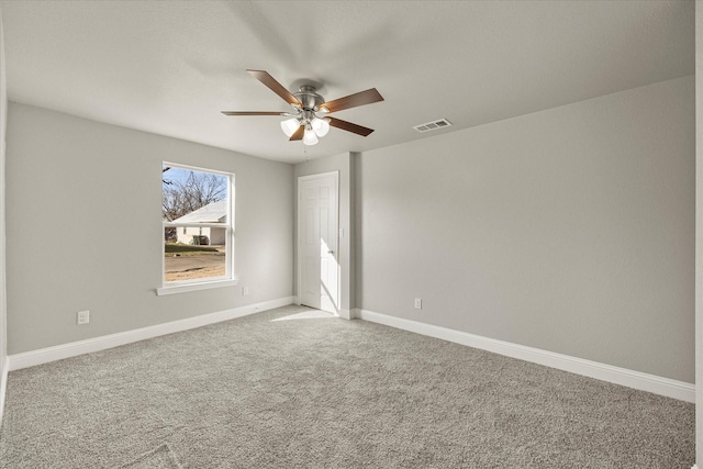 empty room featuring carpet flooring and ceiling fan