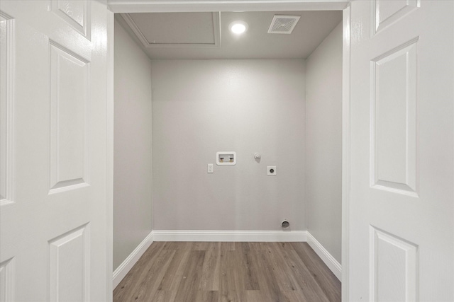 clothes washing area featuring electric dryer hookup, washer hookup, and light wood-type flooring