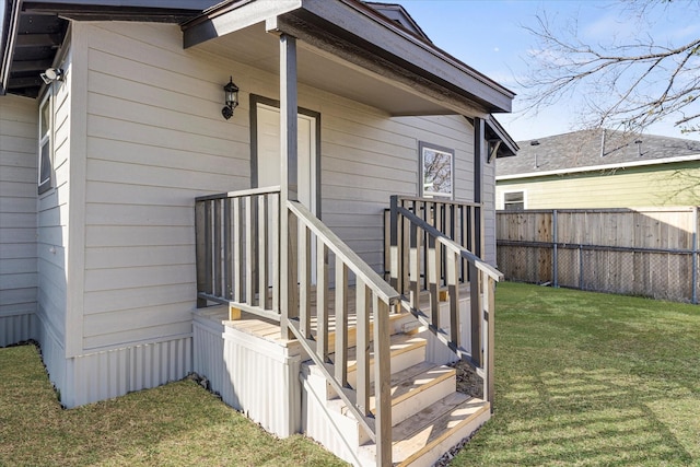 doorway to property with a lawn